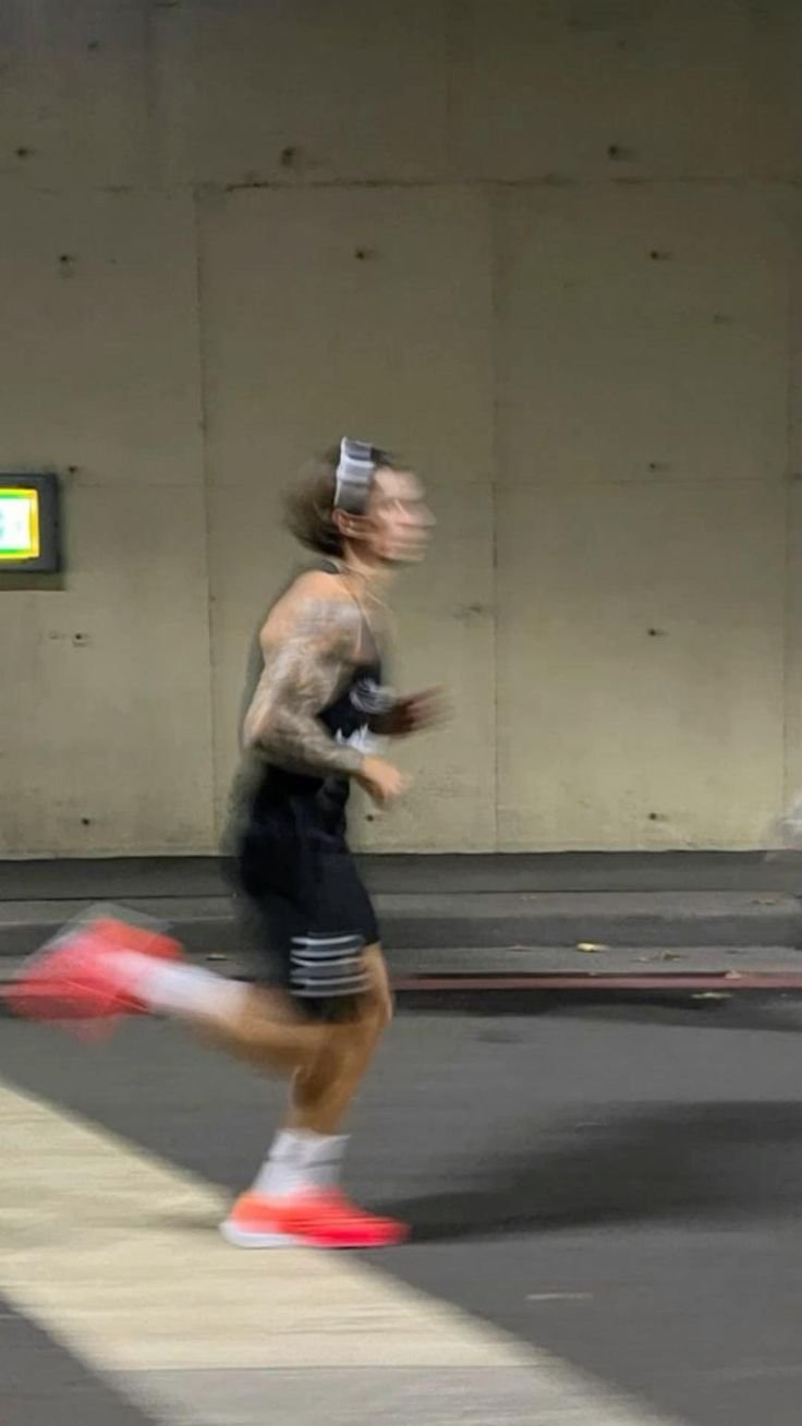 Blurred image of a person jogging, symbolizing the energy and simplicity of incorporating regular exercise into a wellness routine.